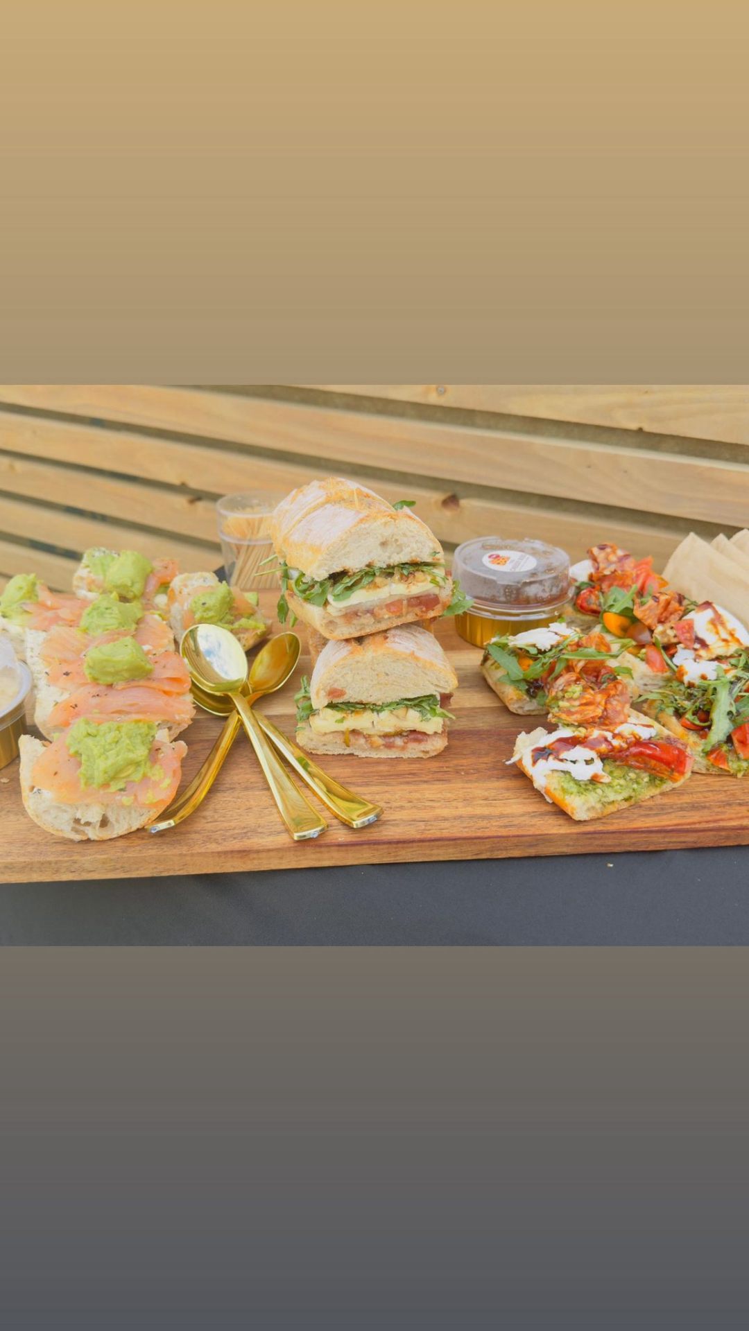 Sharing board of smoked salmon crostini, signature sandwiches and bruschetta