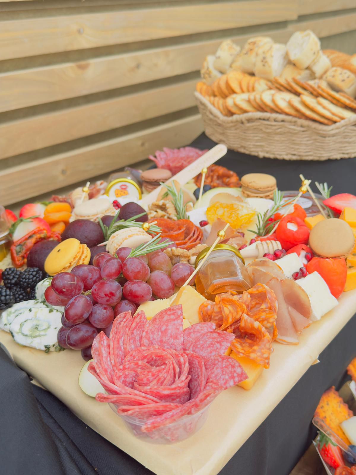 Close-up of luxury grazing board with salami rose, honey, brie and seasonal fruit